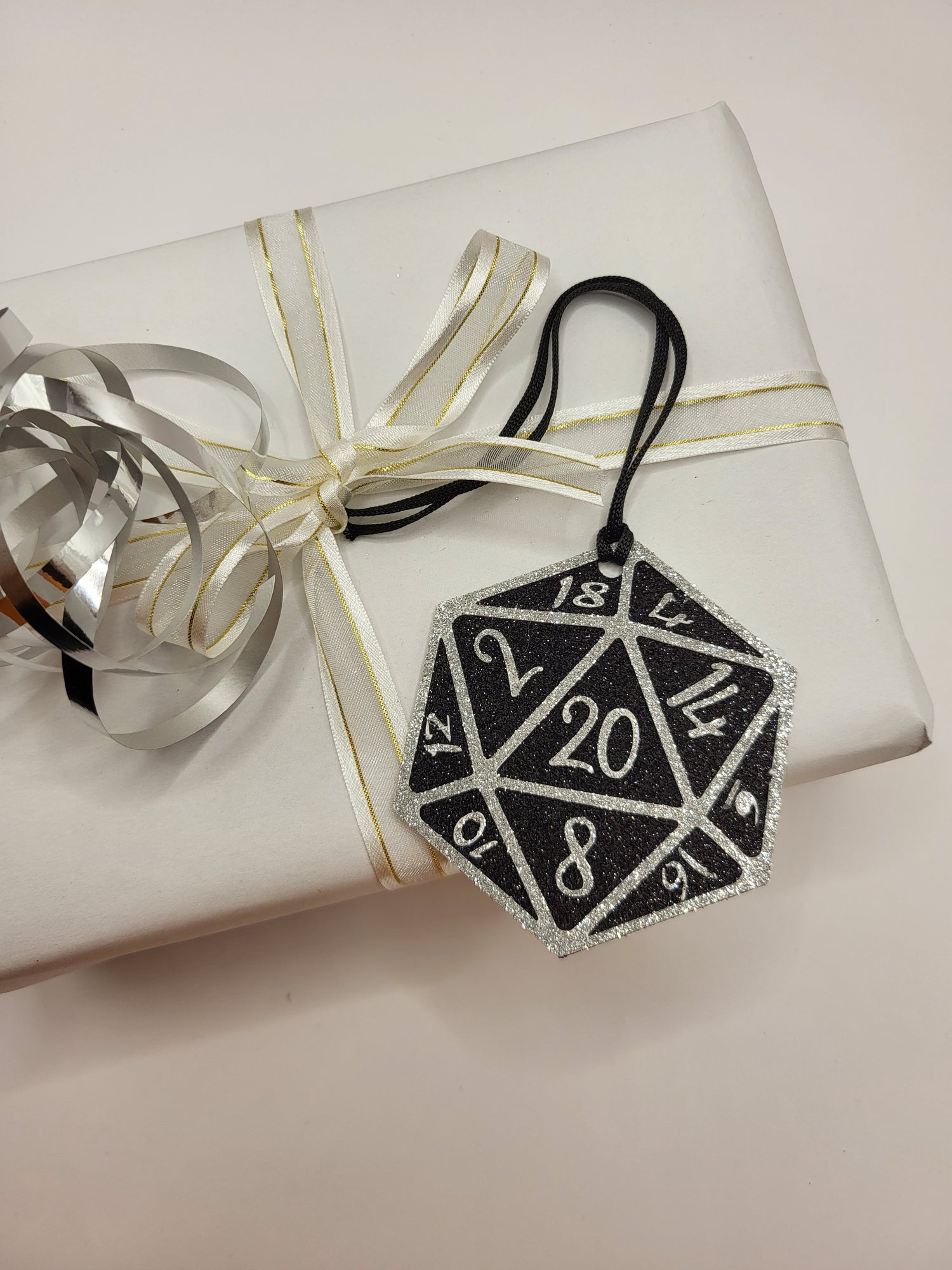 Glitter 20 sided gaming dice. Black background  with silver numbers. Ideal for gaming enthusiasts