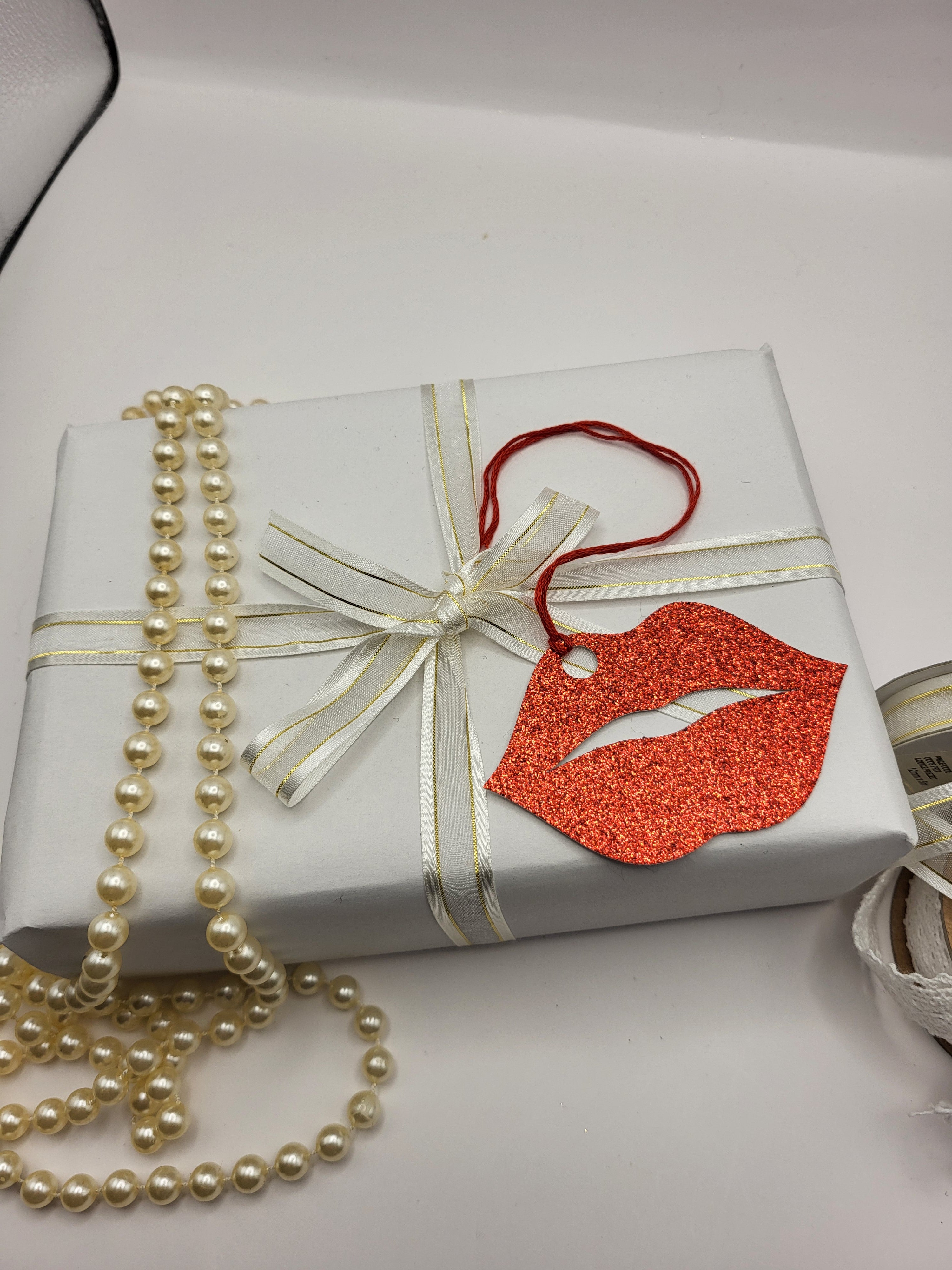 Red glitter kiss lips are made from red glitter card. The tag has a red silk cord attached so you can attach it to a gift