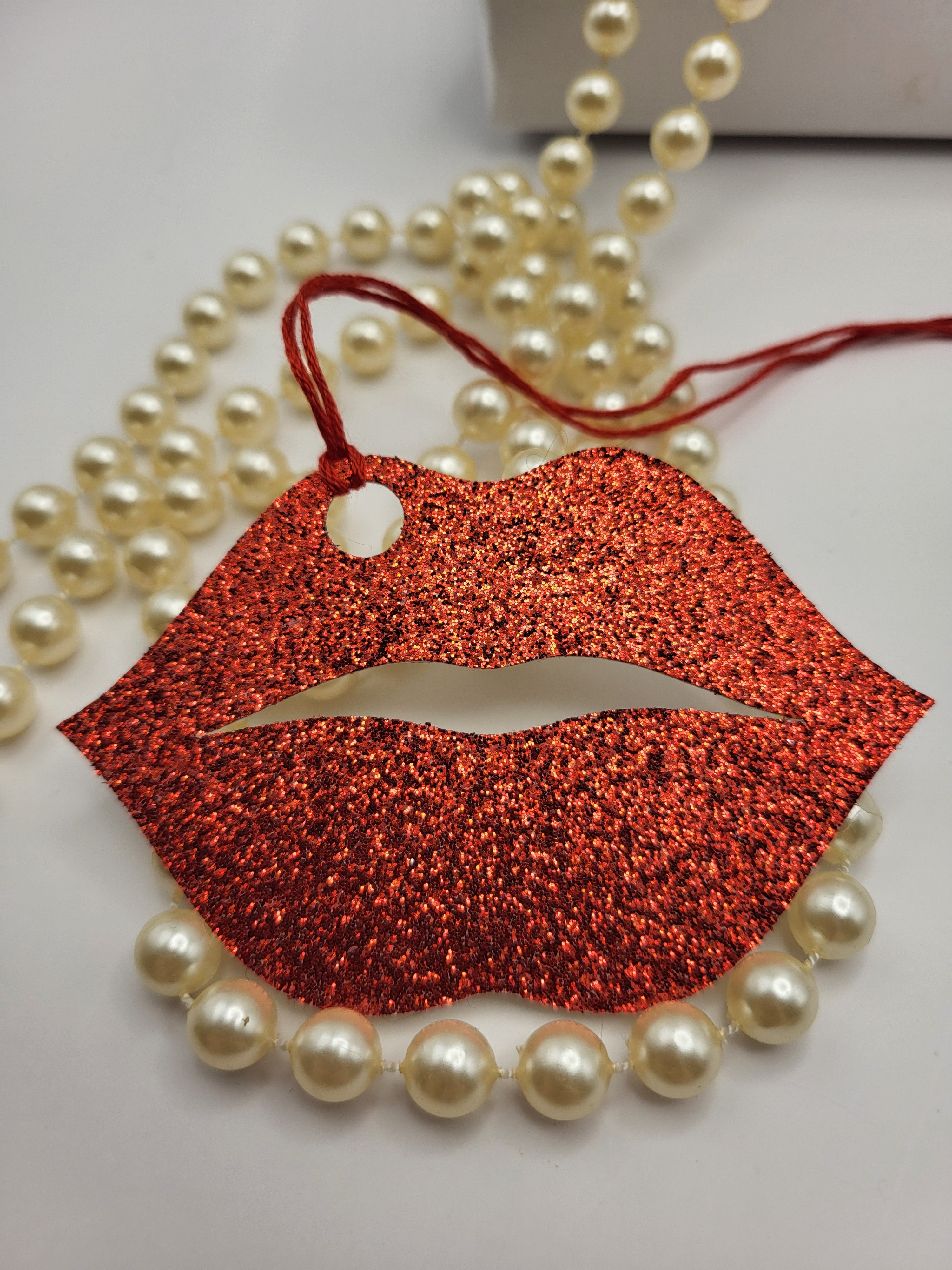 Red glitter kiss lips are made from red glitter card. The tag has a red silk cord attached so you can attach it to a gift