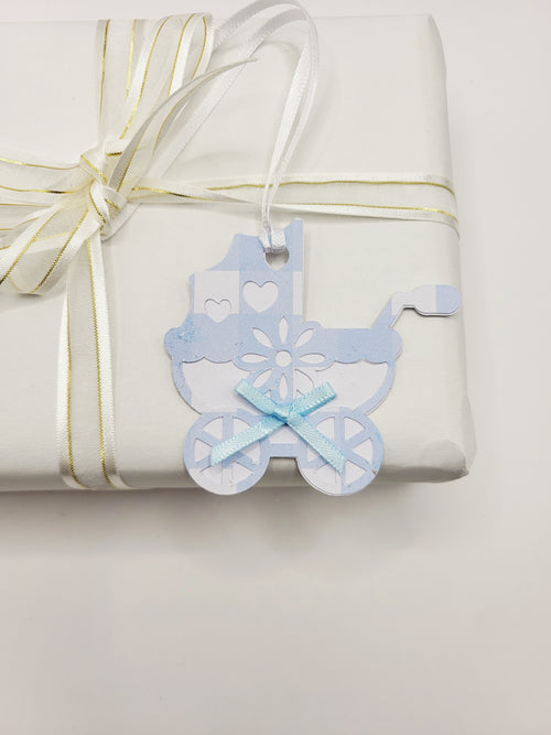 Pram shaped gift tag in blue gingham  on a white background. Pram has a blue bow and a white satin ribbon to attach the tag