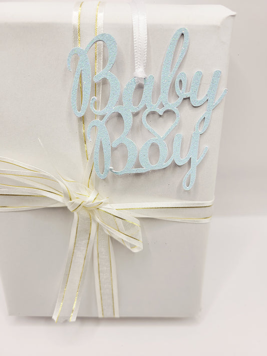 Baby boy decorative gift tag. This tag is non-writeable.  This tag is made from baby blue glitter cardstock and reinforced at the back with 300gsm cardstock. It is finished with a satin ribbon