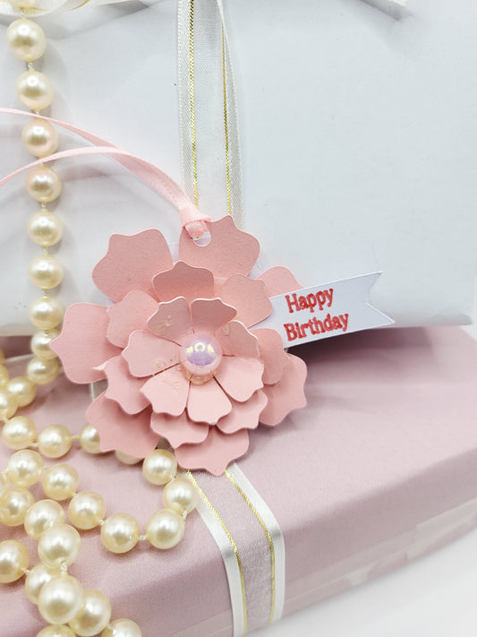 Pink 3d floral gift tag with a flat pearl centre and pink satin ribbon to attach to gift