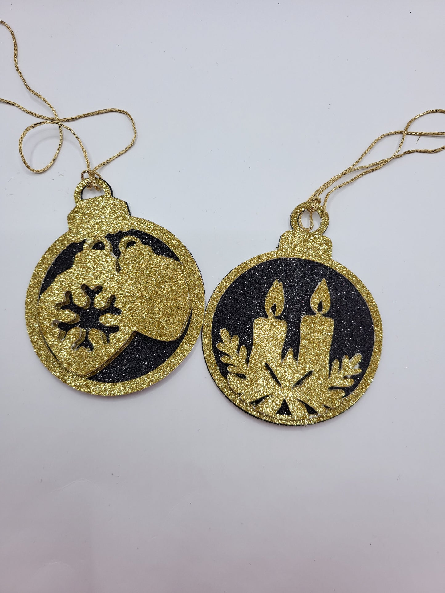 two Christmas bauble gift tags made from black & gold glitter cardstock. One with two candles and the other with tow baubles