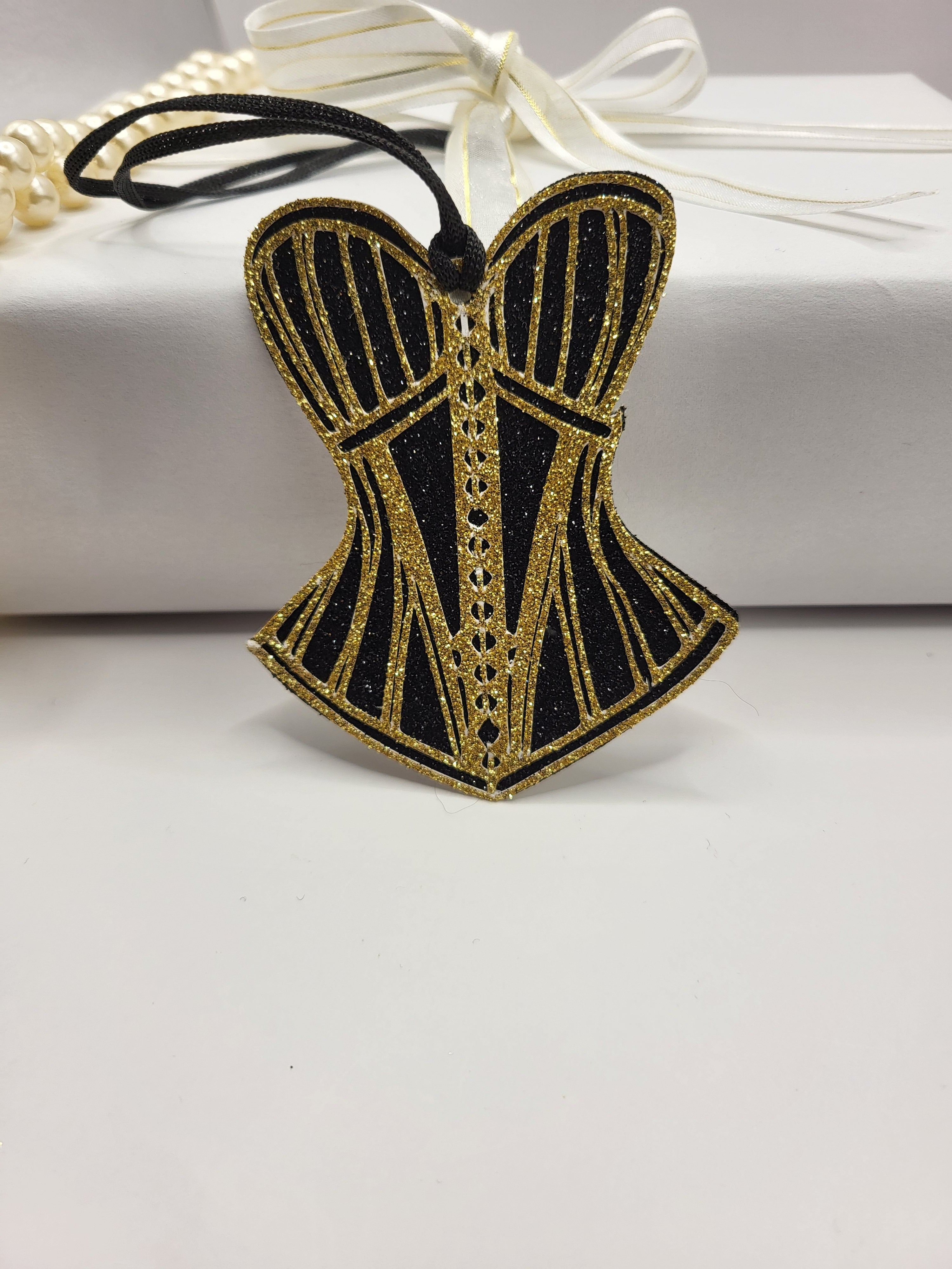Corset shaped gift tag is made from black glitter card with a fancy gold glitter design on top of the black. The tag has a black cord attached so you can attach to any gift