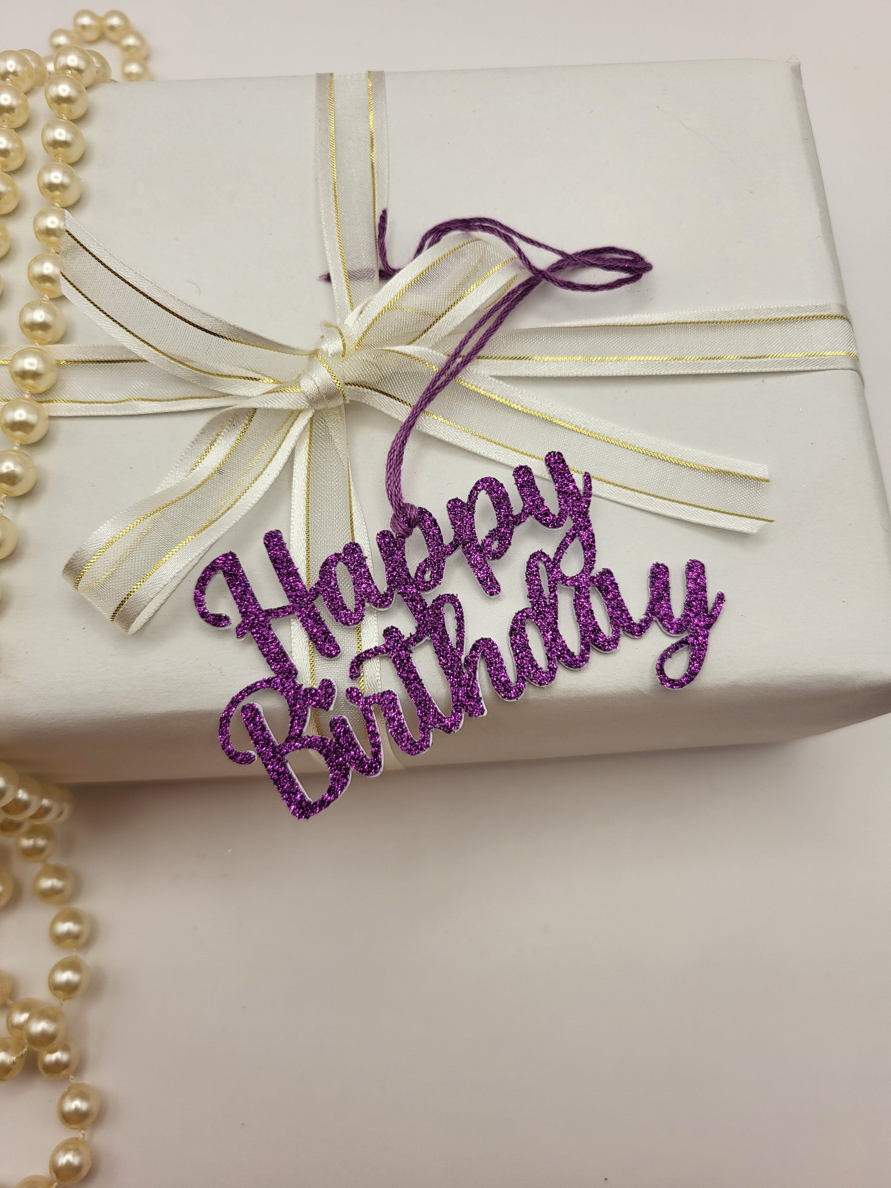 Decorative purple glitter happy birthday gift tag is for decorative purpose only. This tag cannot be written on because it is the words happy birthday only