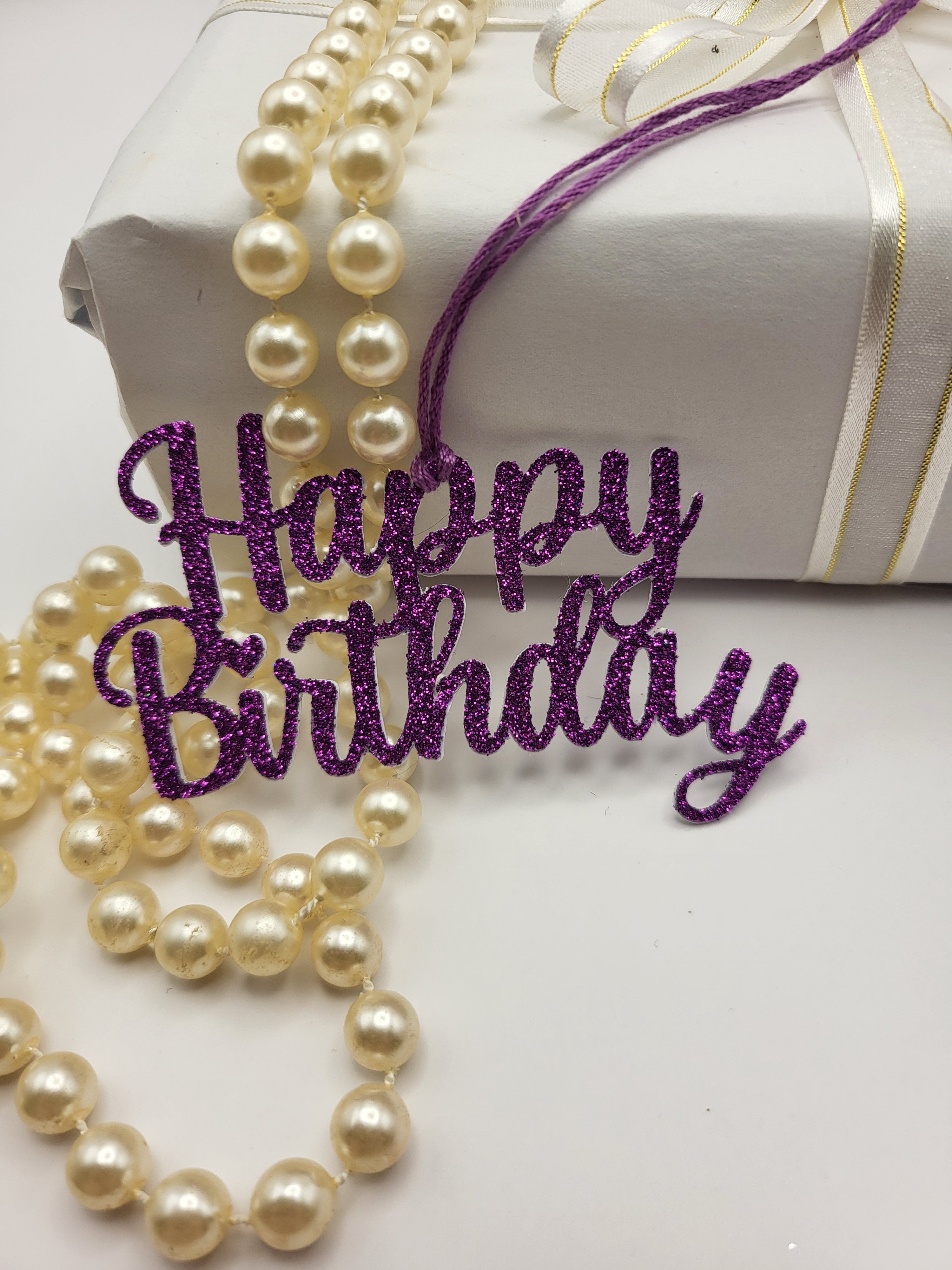 Decorative purple glitter happy birthday gift tag is for decorative purpose only. This tag cannot be written on because it is the words happy birthday only
