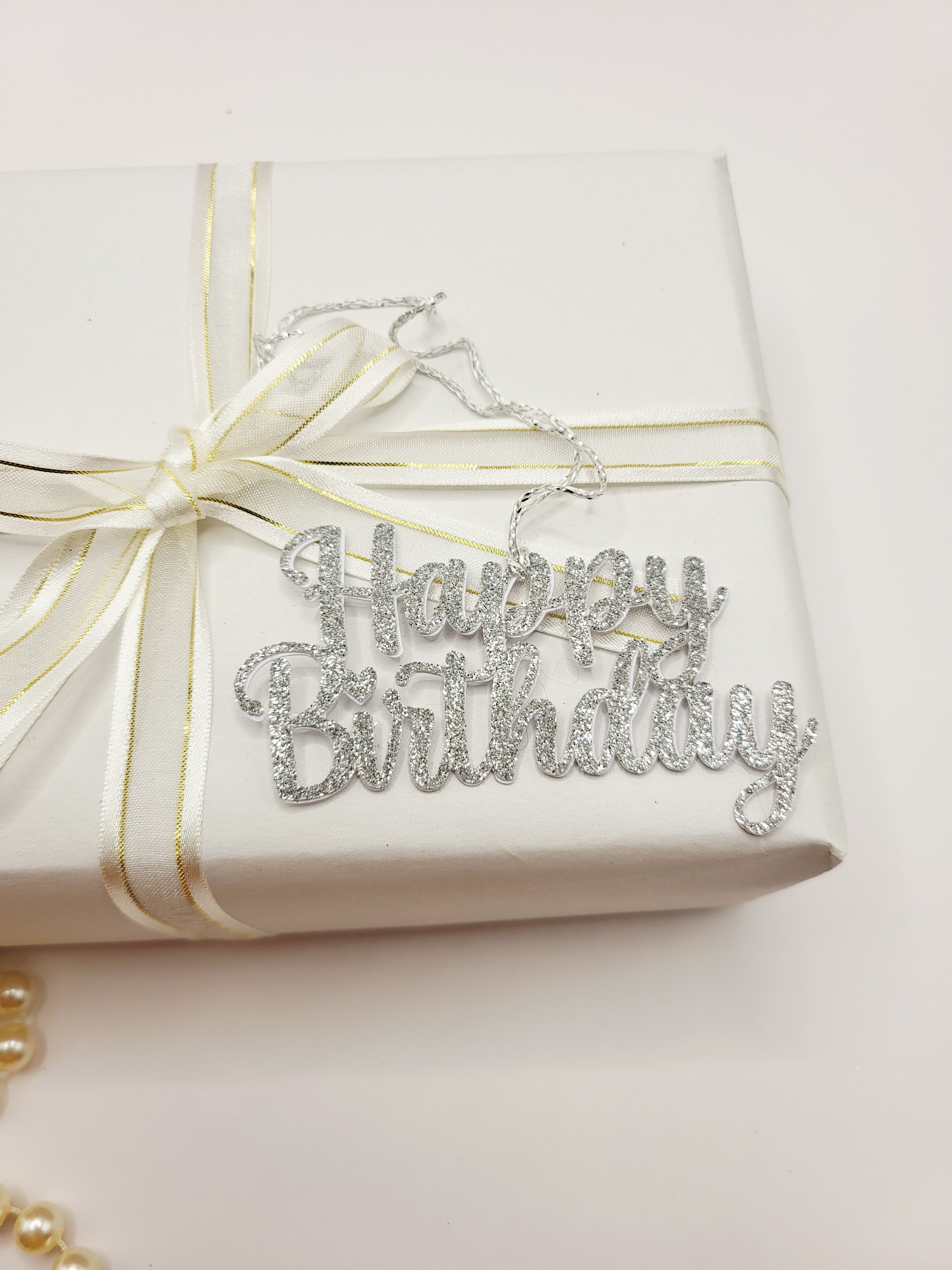 Decorative silver glitter happy birthday gift tag is for decorative purpose only. This tag cannot be written on because it is the words happy birthday only