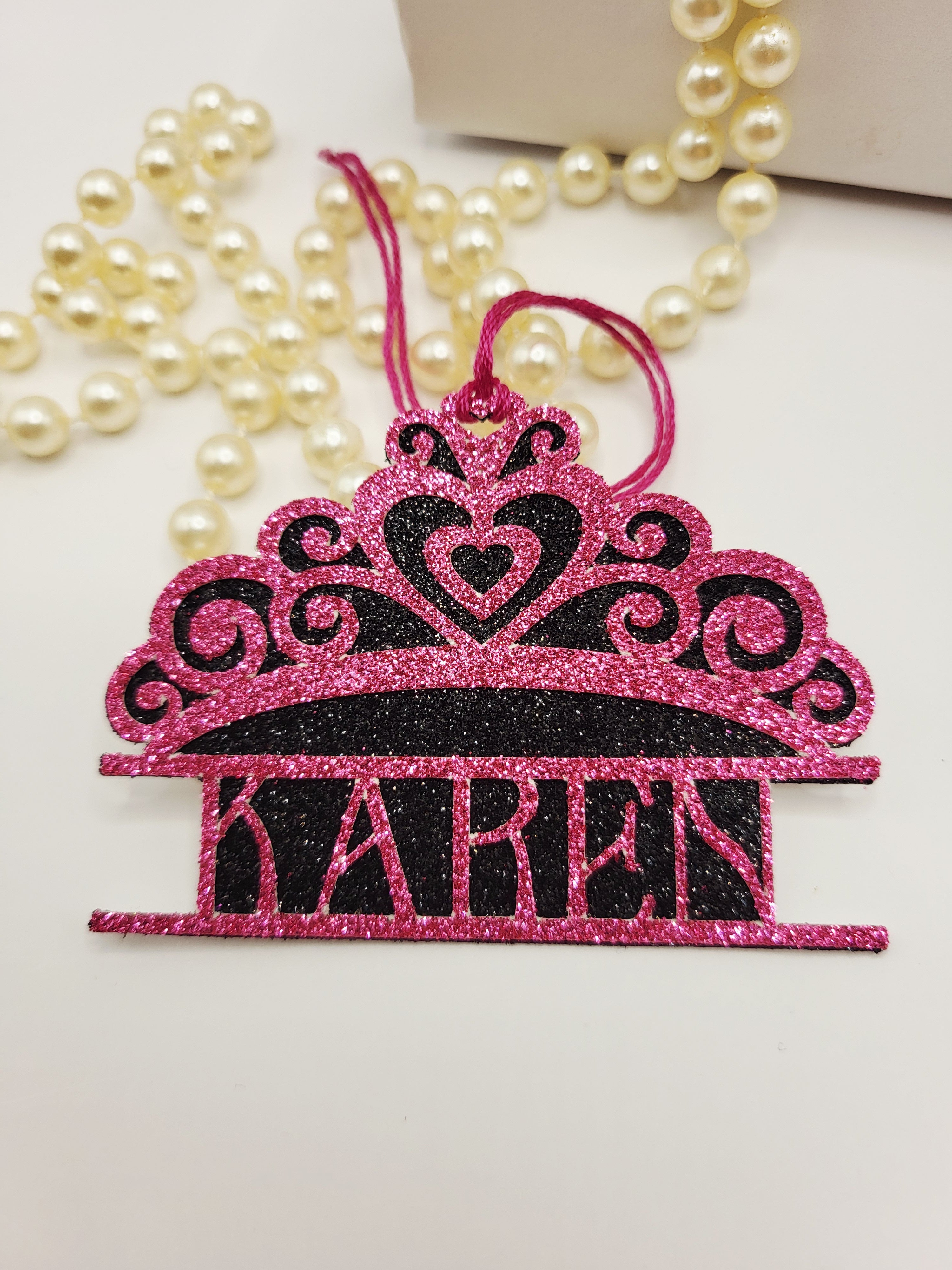 Tiara shaped gift tag is pink glitter card on black glitter card and can be personalised. The tag has a pink silk cord  to enable you to attach to a gift