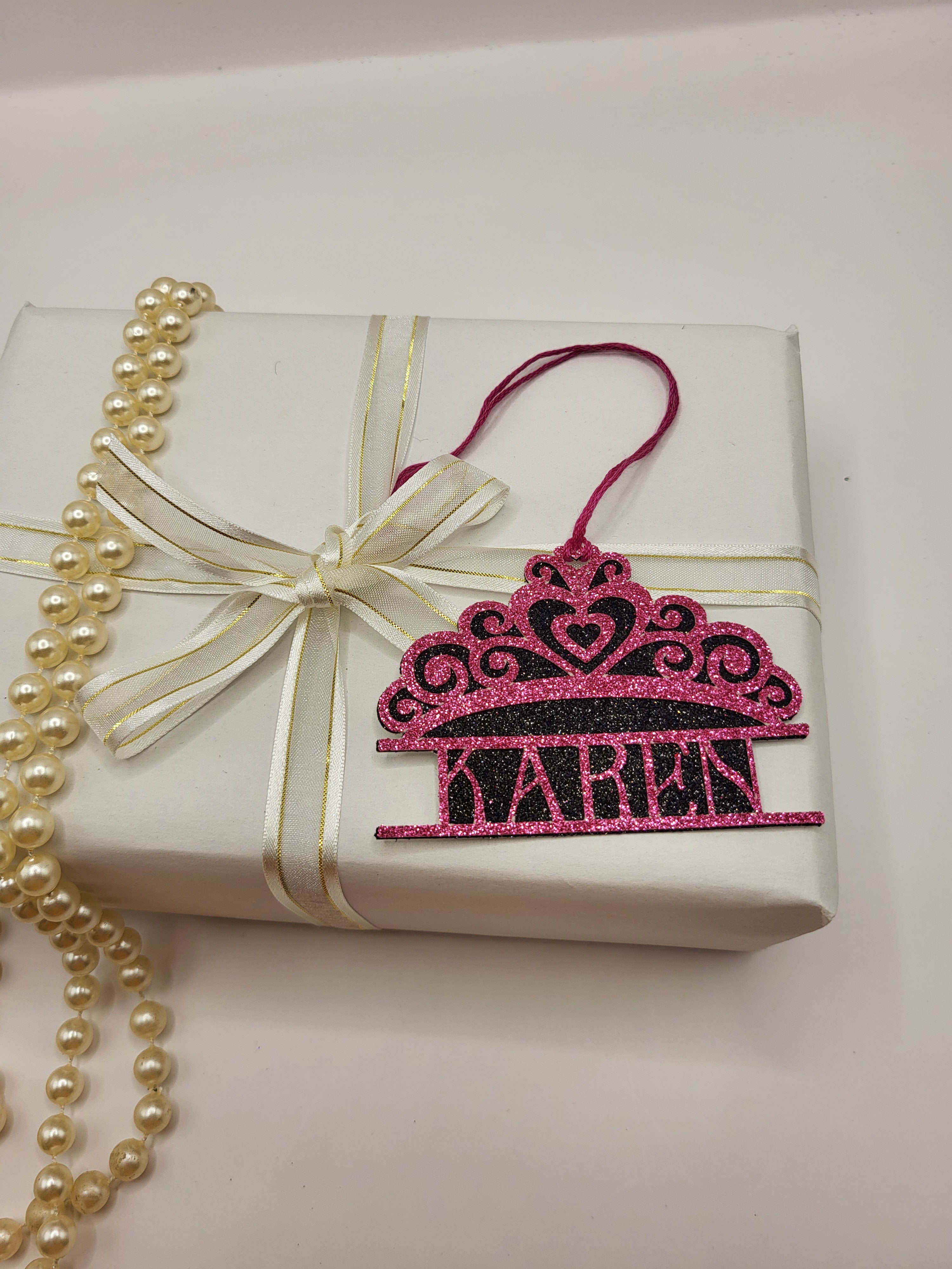 Tiara shaped gift tag is pink glitter card on black glitter card and can be personalised. The tag has a pink silk cord  to enable you to attach to a gift